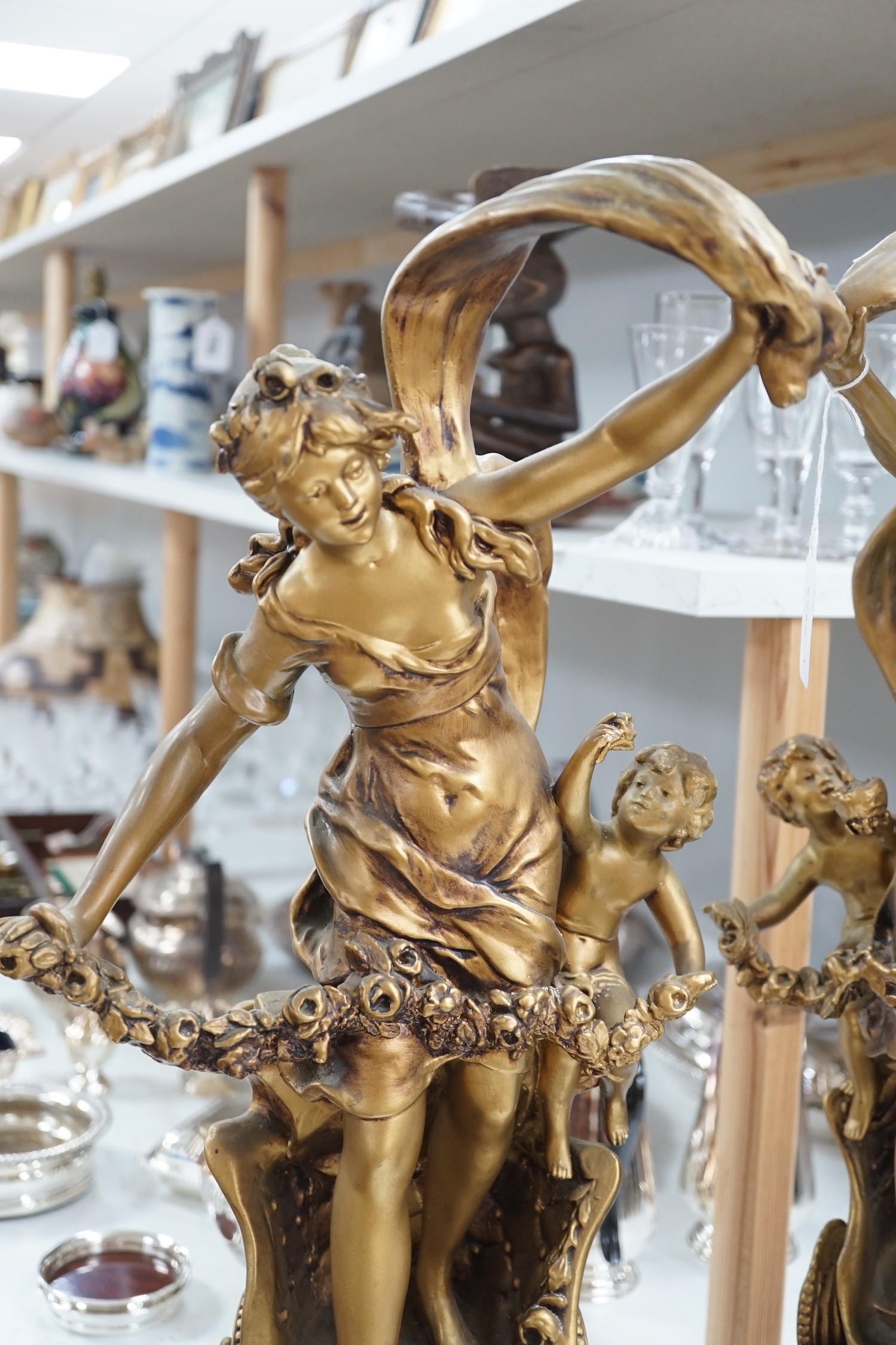 A pair of gilt spelter groups of a classical maiden and cherub, 61cm tall